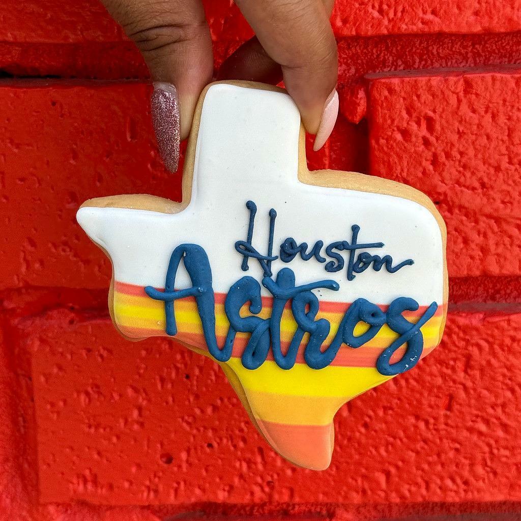 Texas-shaped Astros cookie with orange and yellow stripes.