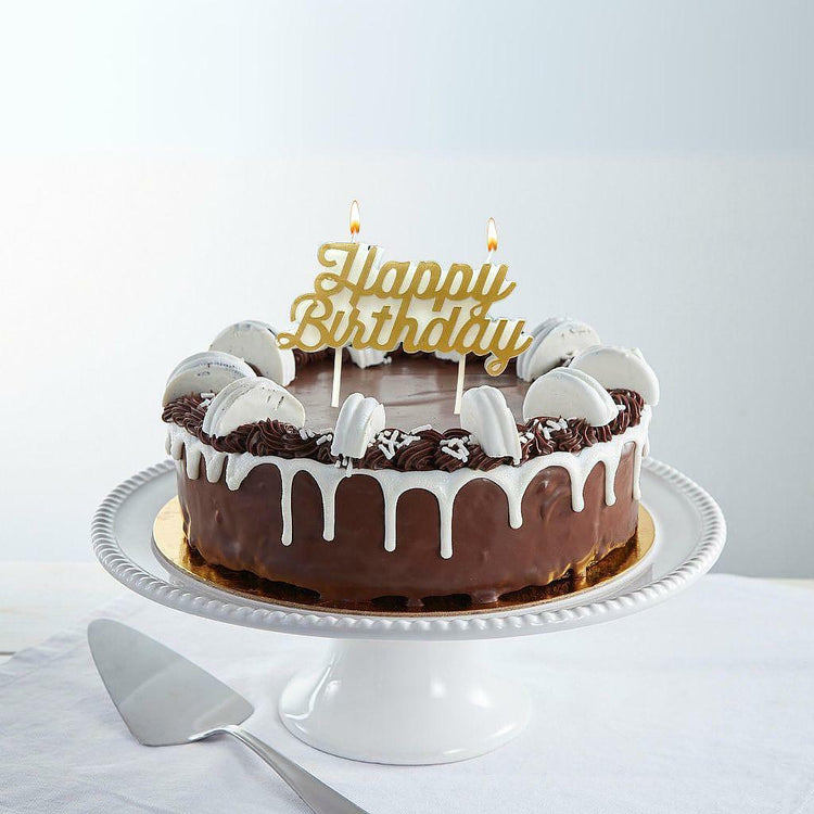 The Big "O" 9-inch chocolate cake with white drip and macarons