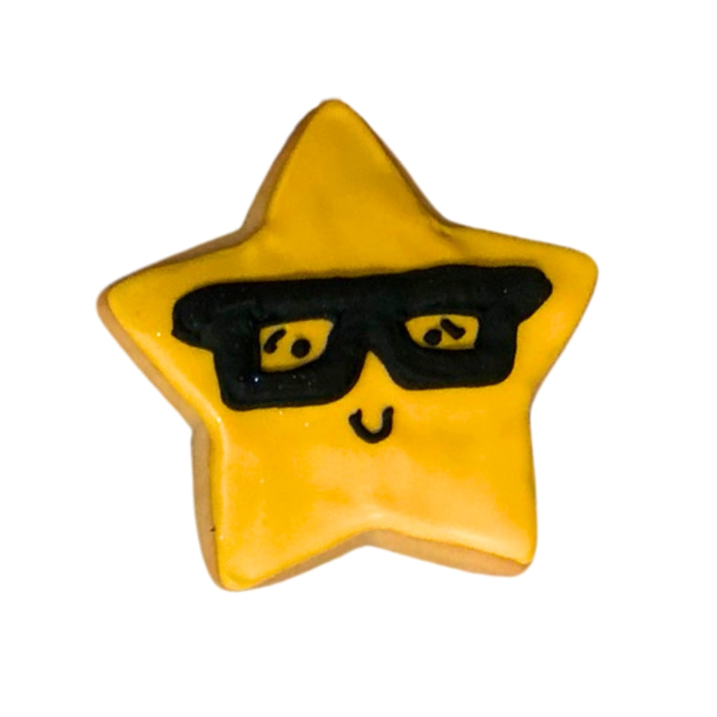 Back to school star-shaped cookie wearing black glasses