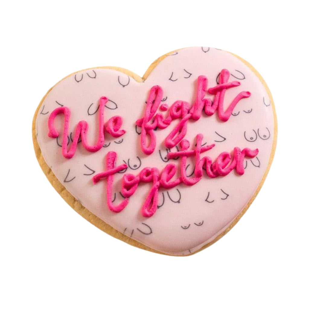 Heart-shaped Breast Cancer Awareness cookie with pink icing.