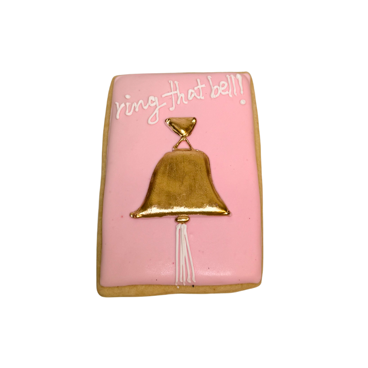 Breast Cancer Awareness cookie with gold bell and icing.
