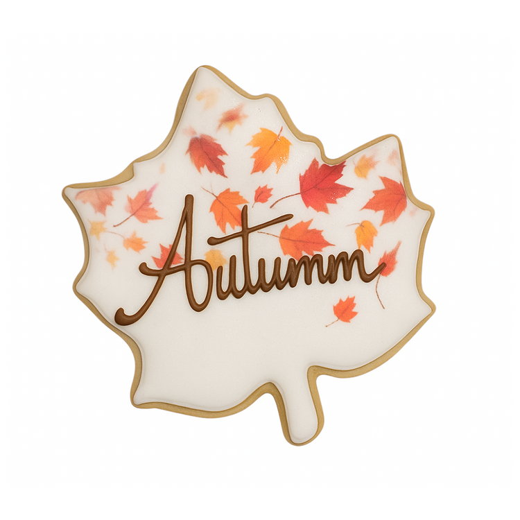 Fall leaf-shaped cookie with Autumn text and orange foliage.