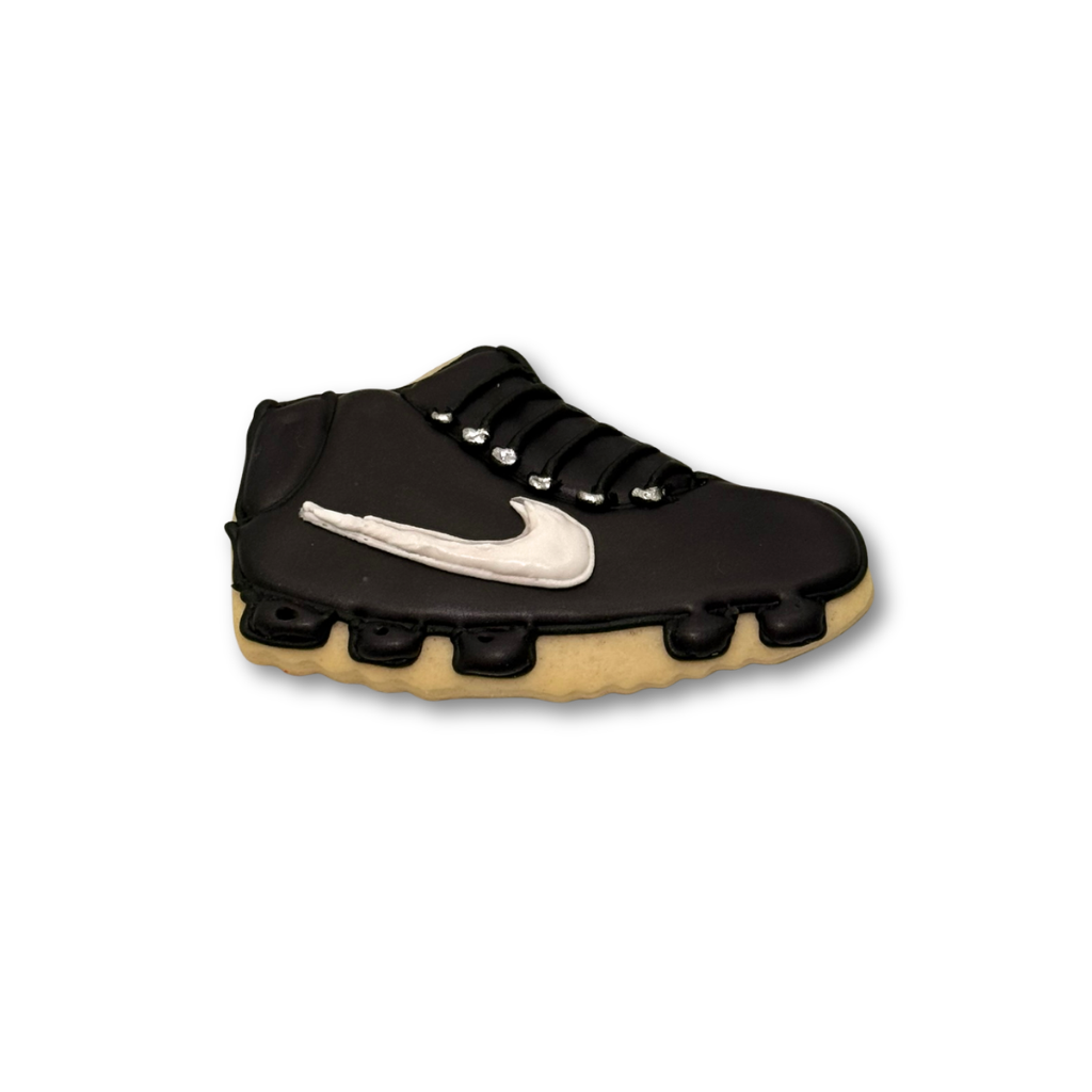 World Cup sneaker cookie with black icing and white swoosh.
