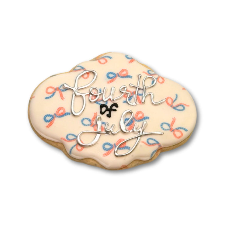 4th of July cookie with red and blue bow pattern icing