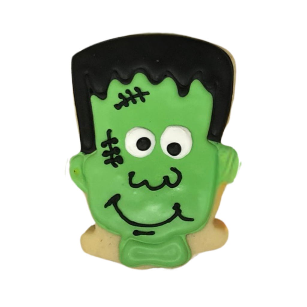 Halloween cookie shaped like Frankenstein with green icing.