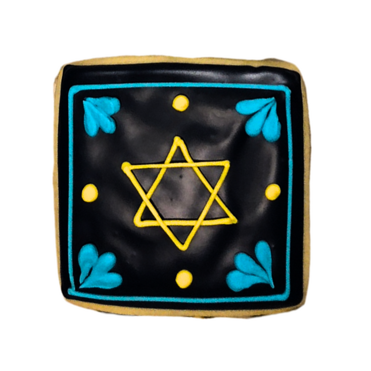 Square Hanukkah cookie with black icing and yellow Star of David