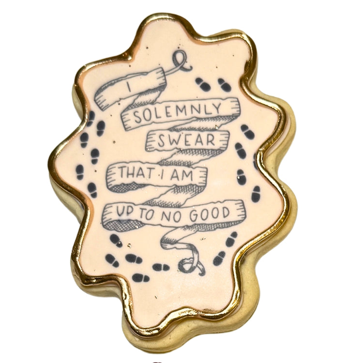 Harry Potter cookie with Marauder's Map quote and gold trim.