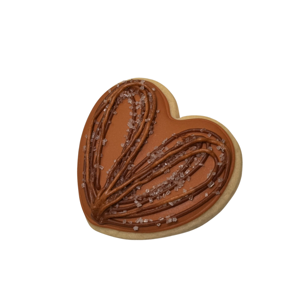 Hispanic Heritage heart-shaped cookie with brown icing.