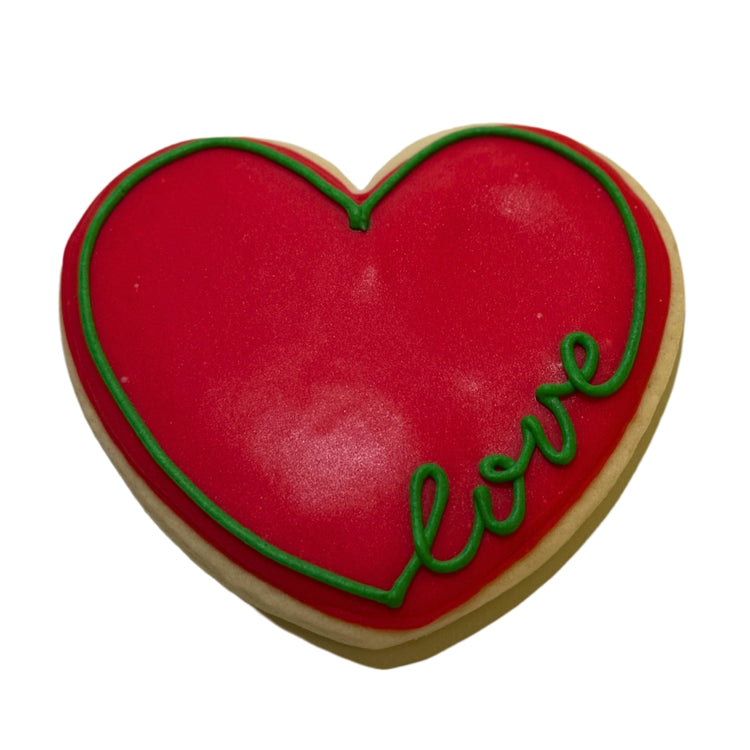 Heart-shaped Juneteenth cookie with red icing and green love text.