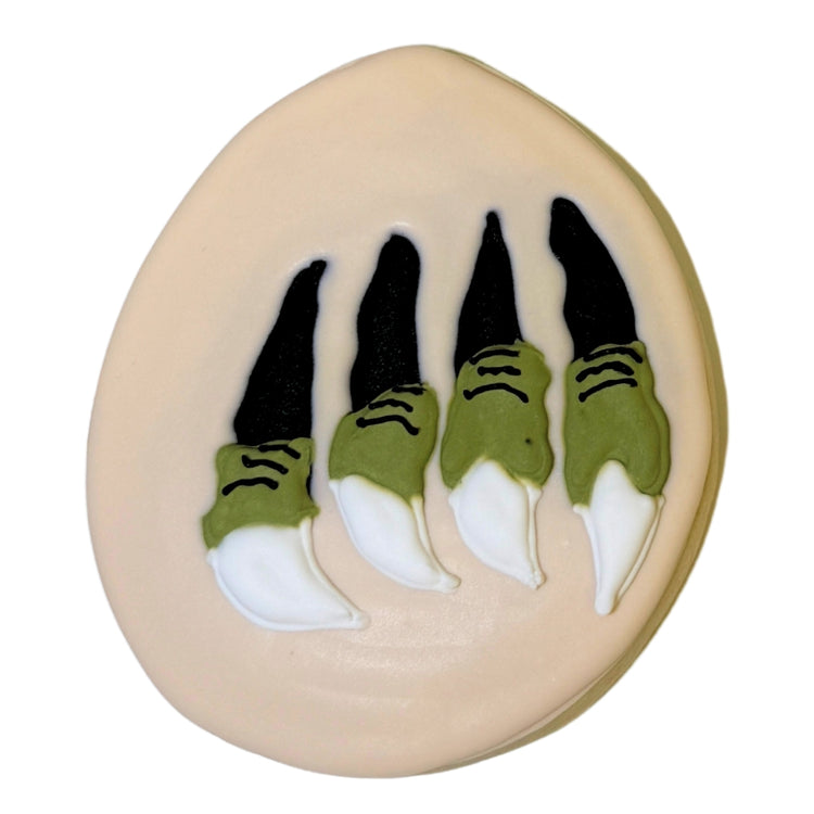 Jurassic Cookie with green and white dinosaur claw icing.