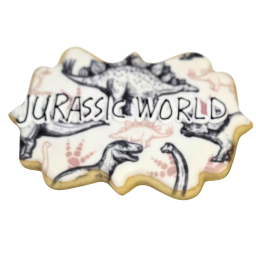 Jurassic World cookie with black and white dinosaur patterns.