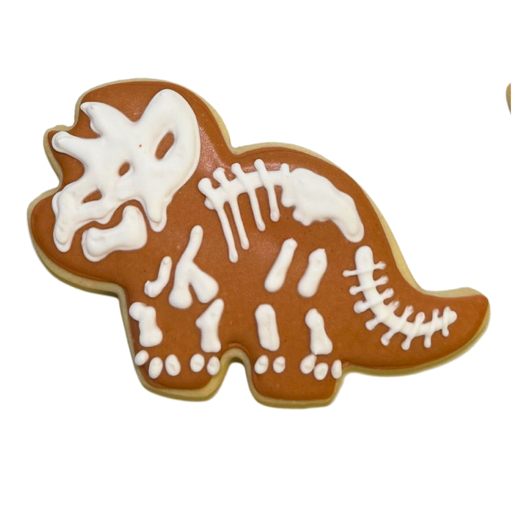 Jurassic cookie shaped like a triceratops with white icing bone.