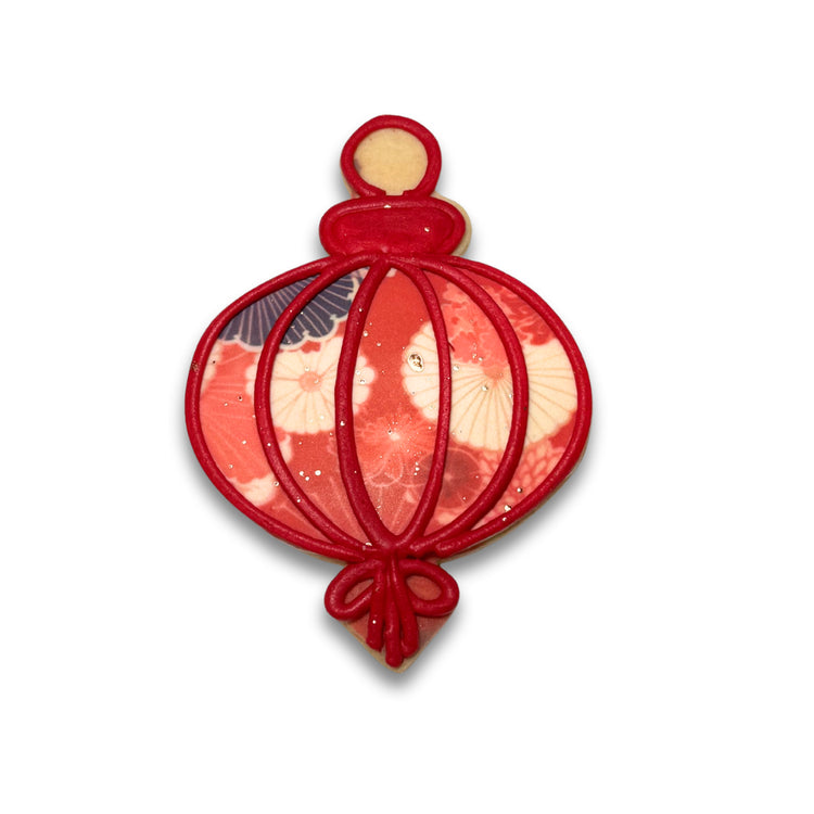 Lunar New Year cookie shaped like a red floral lantern.