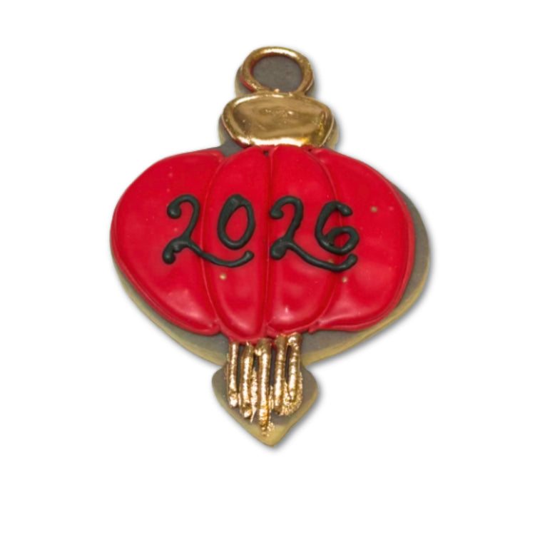 Lunar New Year cookie shaped like a red 2026 lantern.