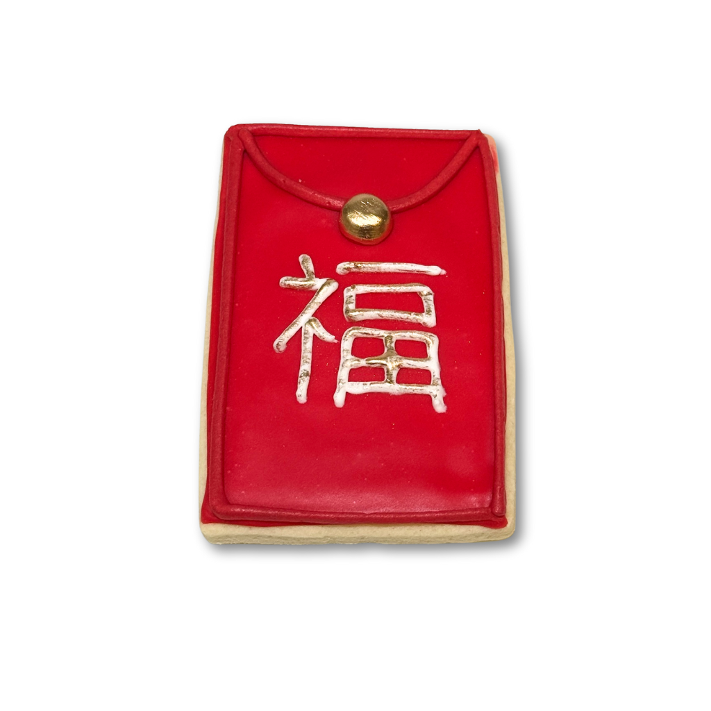 Lunar New Year cookie shaped like a red envelope with gold detail.