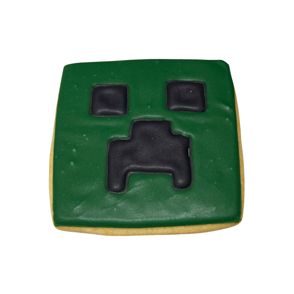 Square Minecraft Creeper cookie with green and black icing.