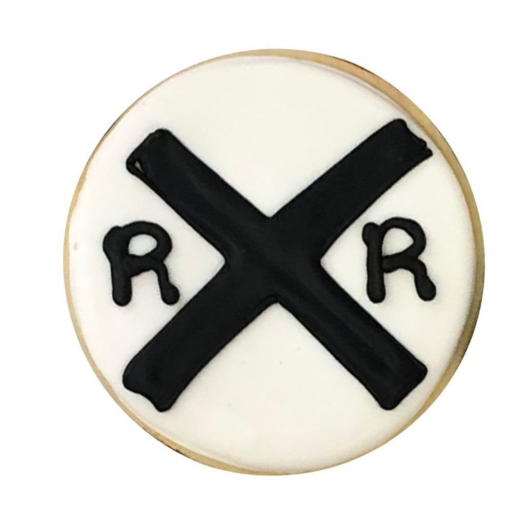Round train theme cookie with black railroad crossing sign.