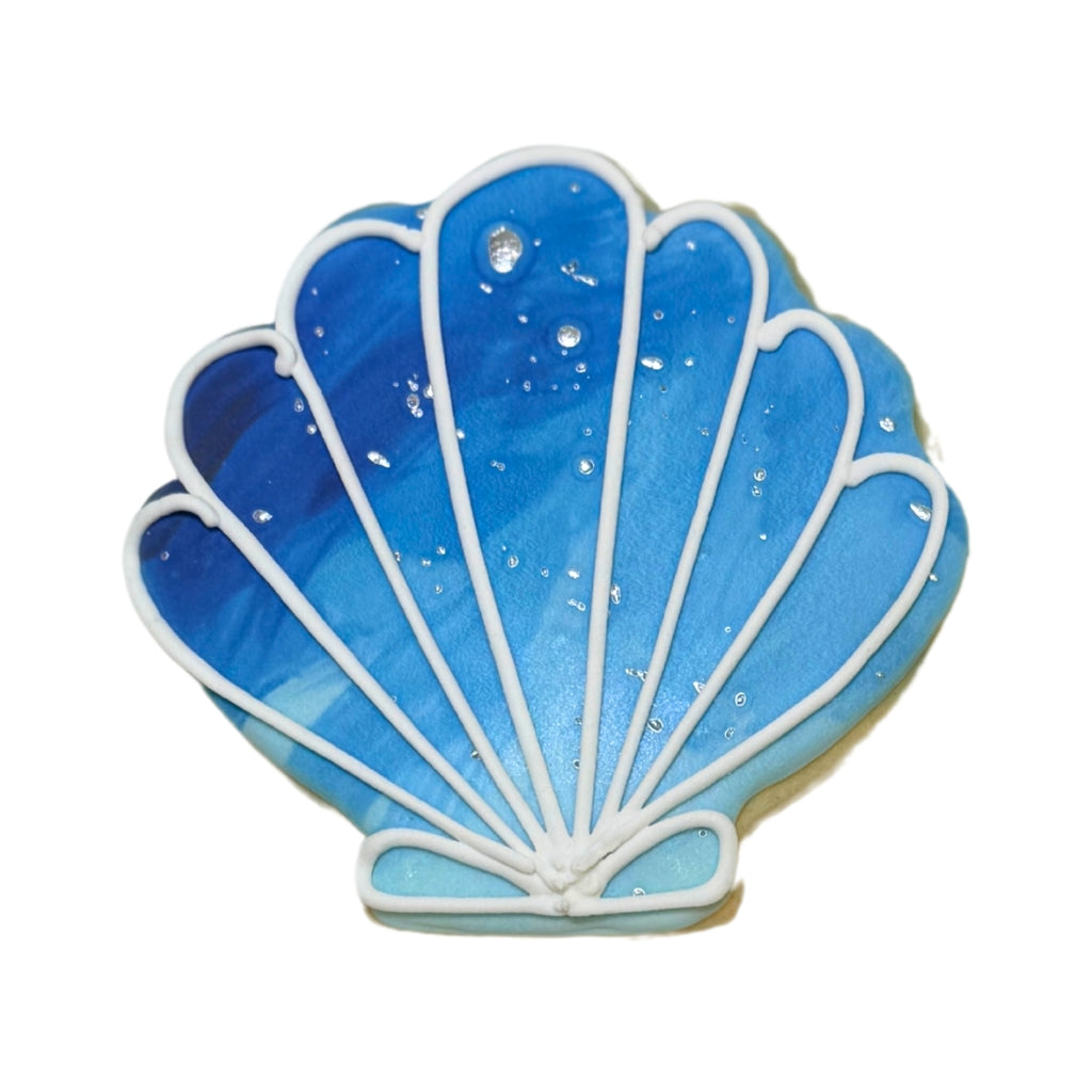 Summer Cookie shaped like a blue seashell with white icing.