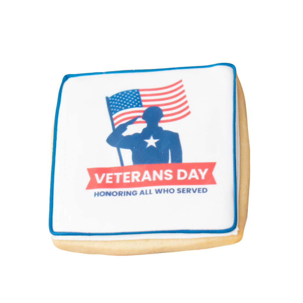 Square Veterans Day cookie with soldier and flag graphic.