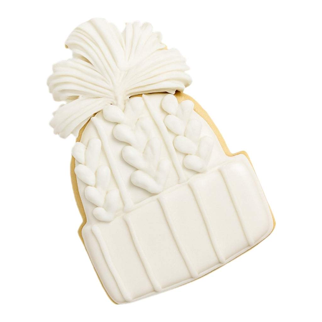Christmas Couture cookie shaped like a white knit beanie hat.