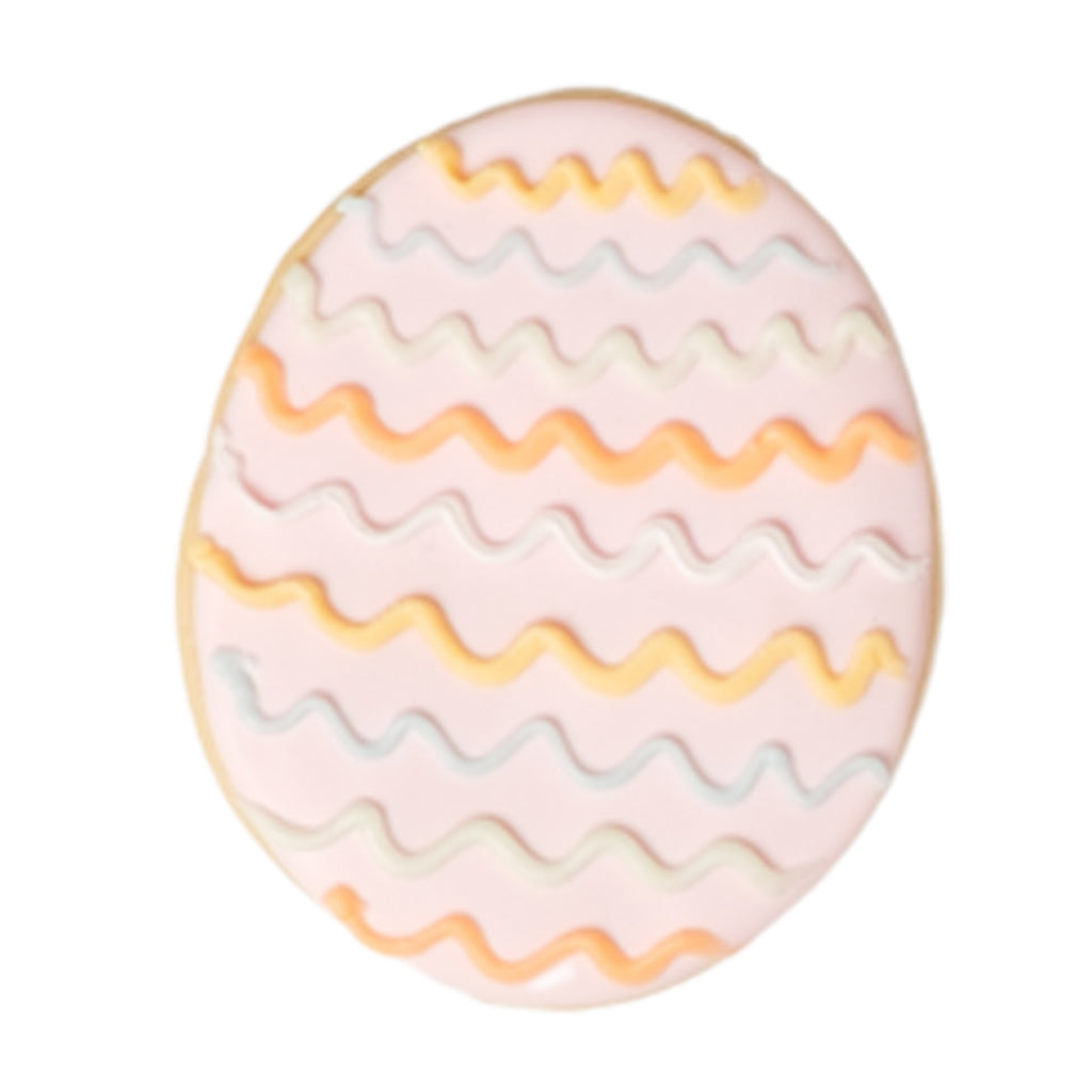 Easter butter cookie with pink icing and wavy lines.