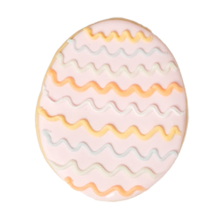 Easter butter cookie with pink icing and wavy lines.