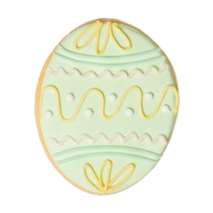 Easter butter cookie with green and yellow icing patterns.
