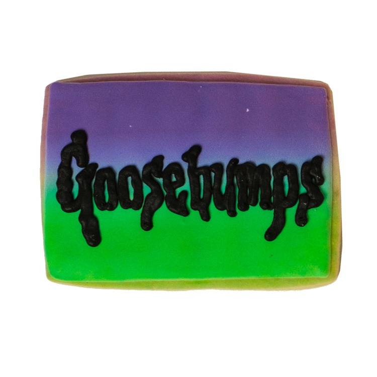 National Reading Month cookie with purple and green icing.