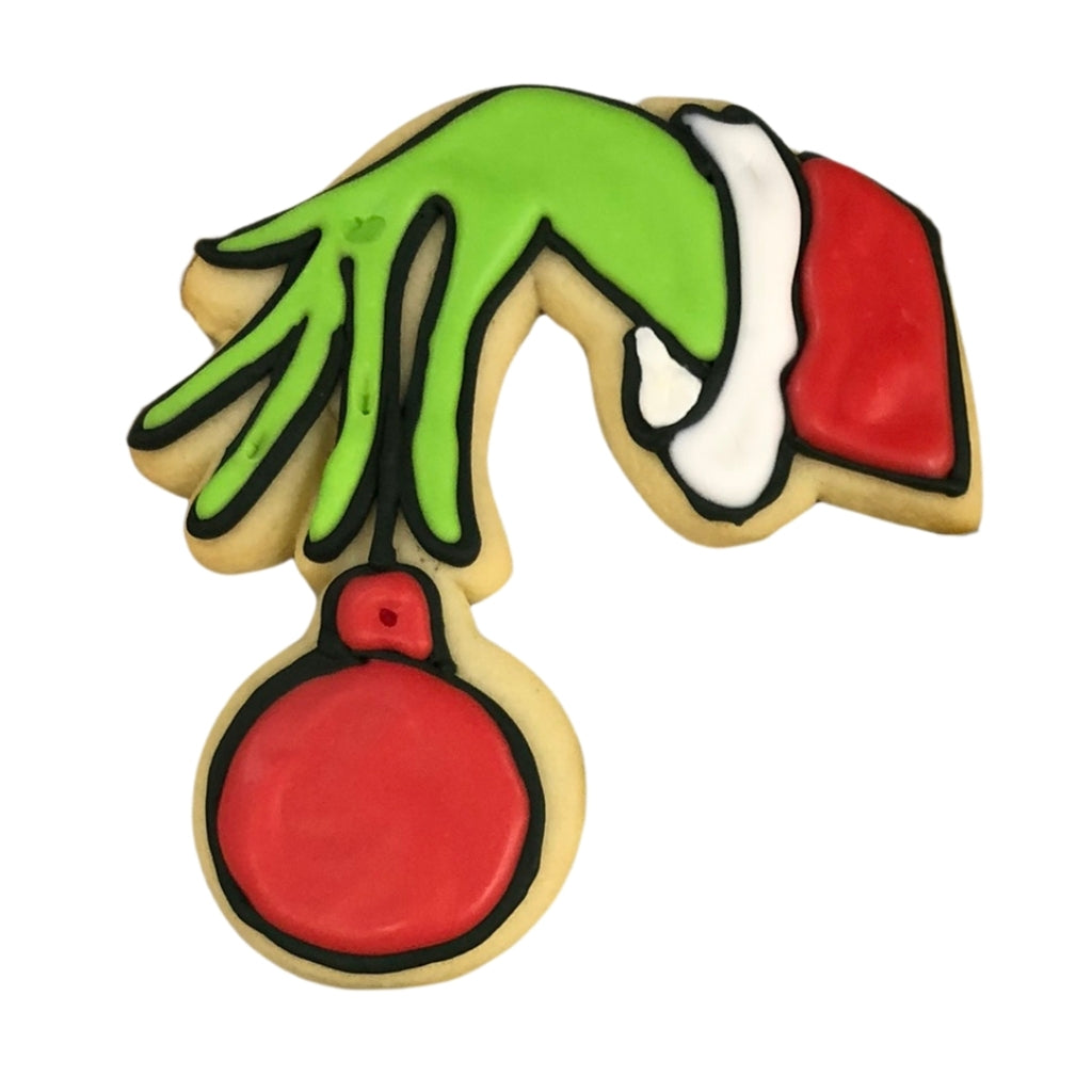 Christmas Characters cookie shaped like a green Grinch hand.