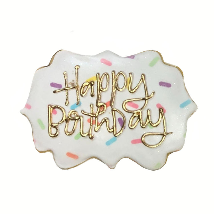 Happy Birthday plaque with white icing and colorful sprinkles.
