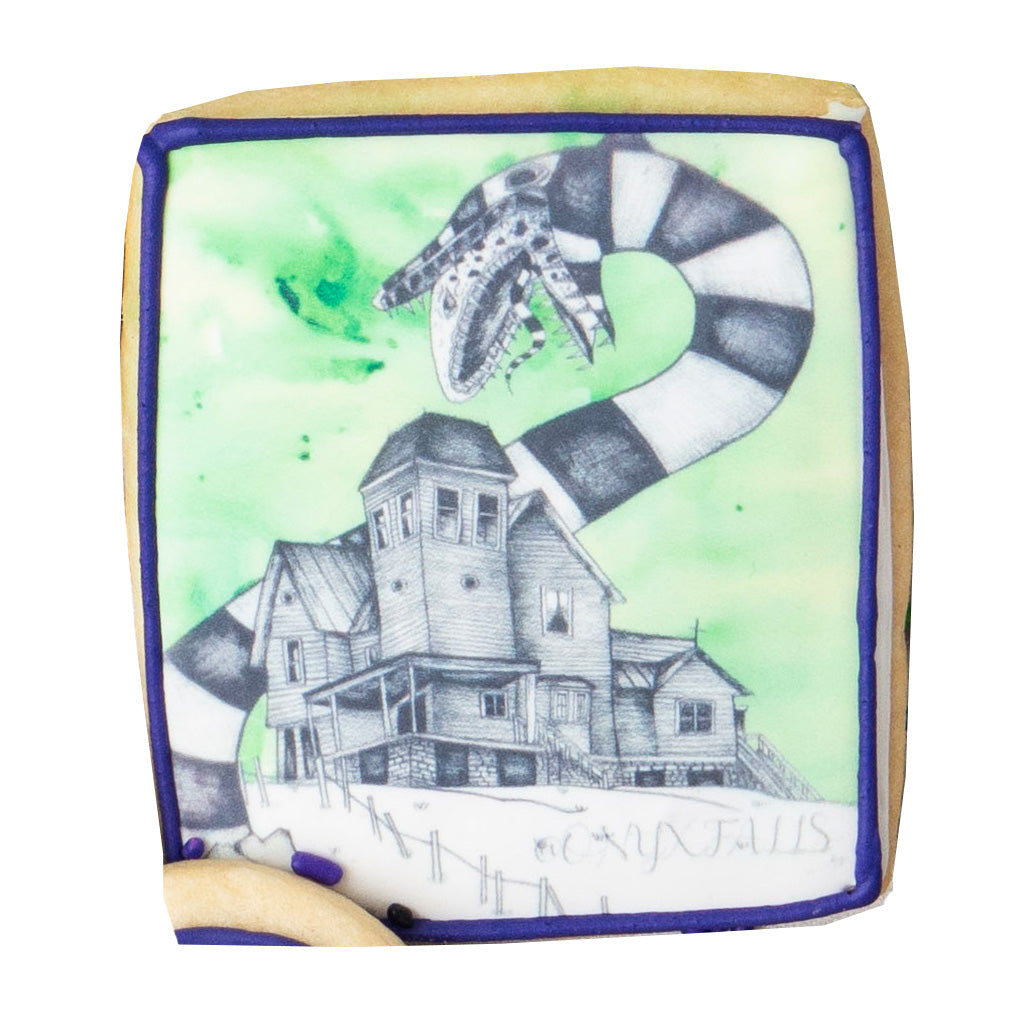 Beetlejuice butter cookie with a sandworm and house illustration.