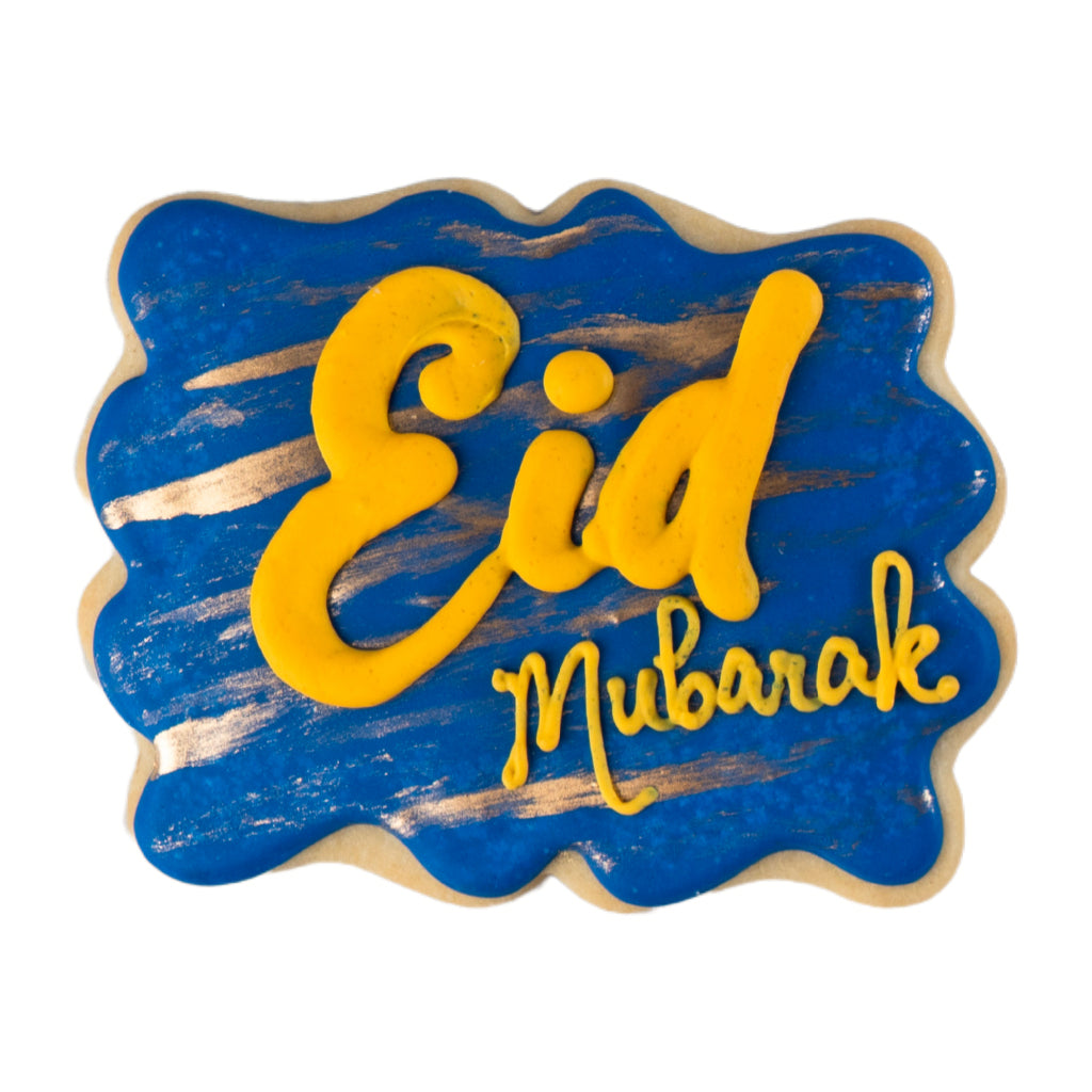 Eid Mubarak butter cookie with blue icing and gold lettering.