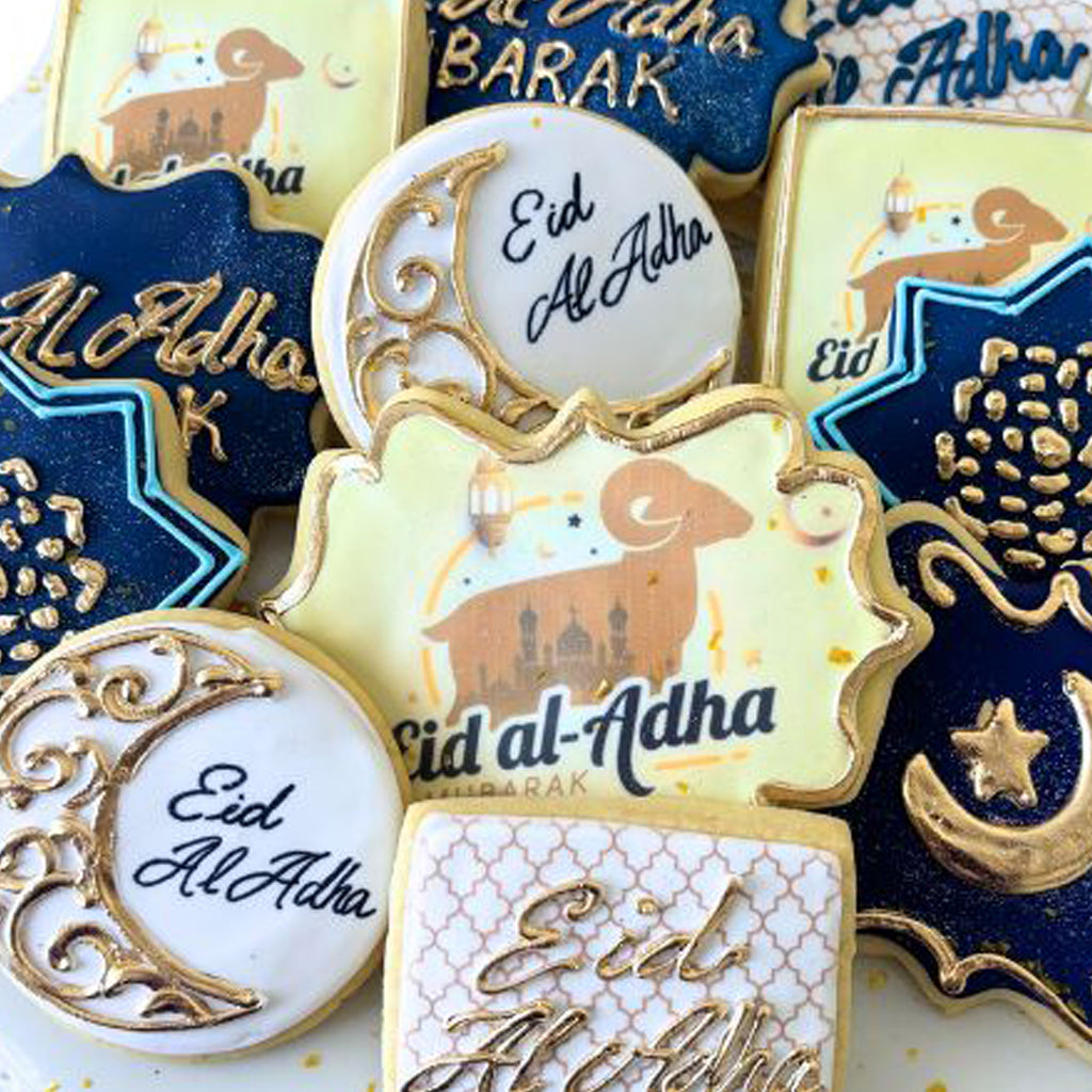 Assorted Eid al Adha cookies with gold and navy icing.