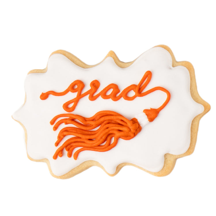 Graduation tassel cookie with orange icing on white background