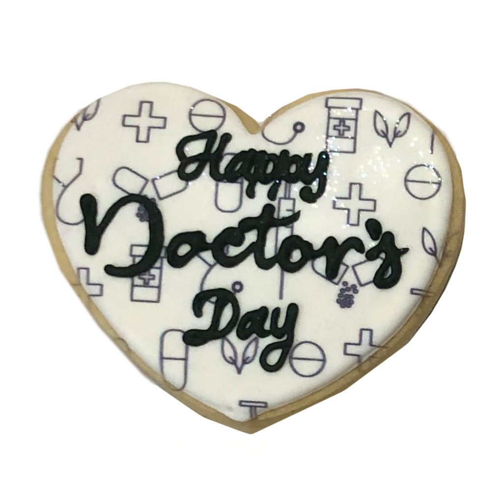 Heart-shaped Doctor's Day cookie with medical icon pattern.