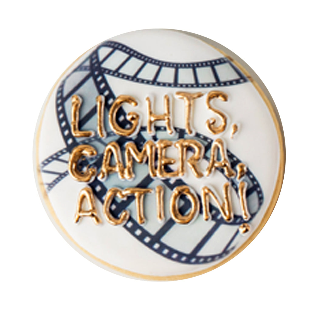 Academy Awards cookie with gold text and film strip design.