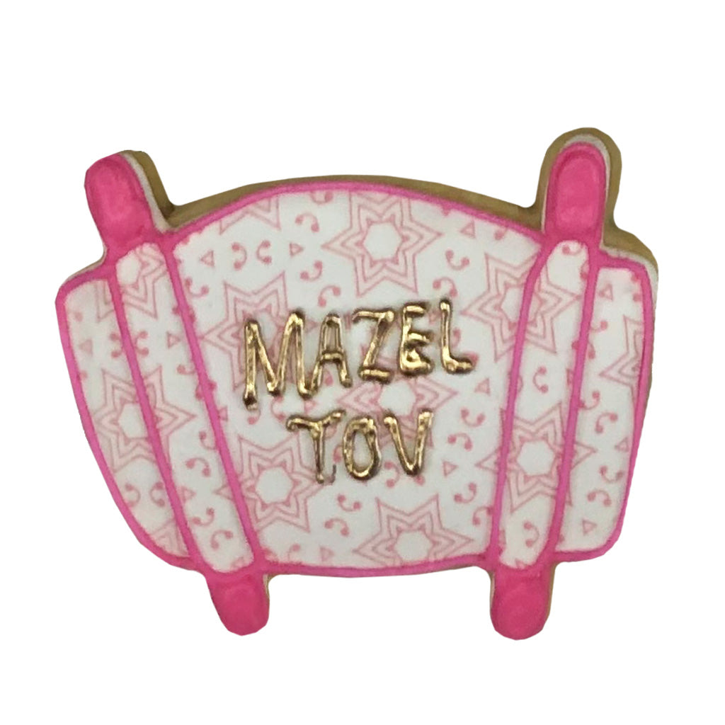 Mazel Tov Torah cookie with pink star patterns and gold text.