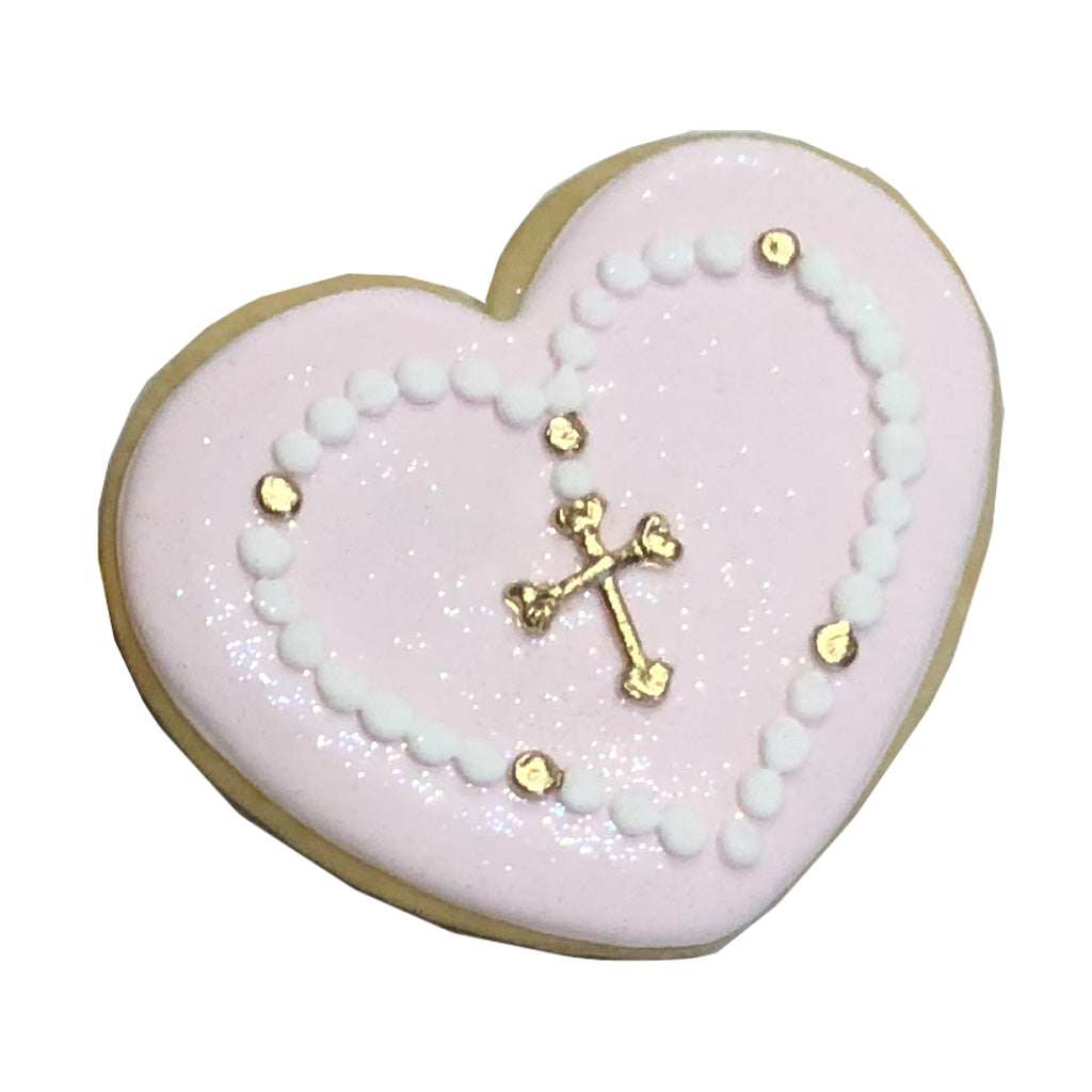 Heart-shaped Baptism cookie with pink icing and gold cross.