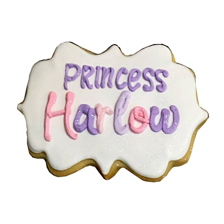 Princess Theme cookie with purple and pink icing lettering