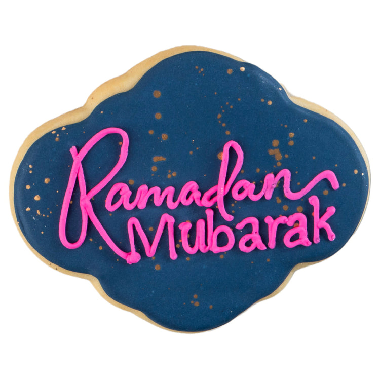 Ramadan Mubarak butter cookie with blue icing and pink script.