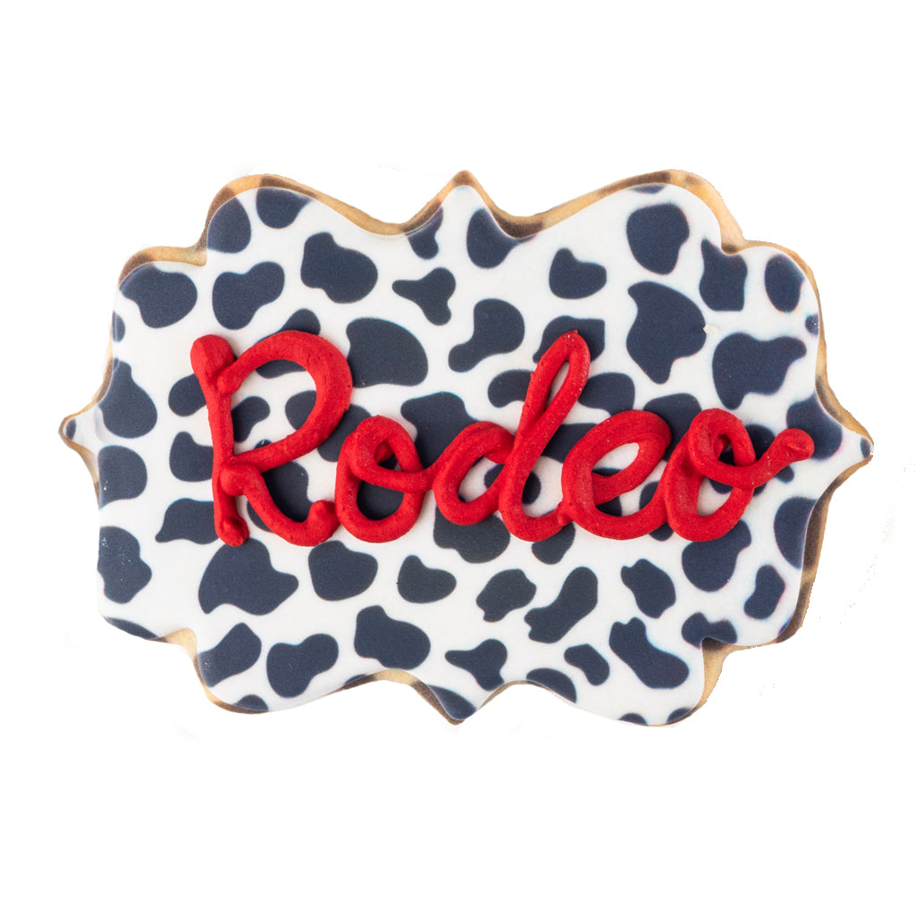 Texas icon cookie with cow print and red Rodeo icing