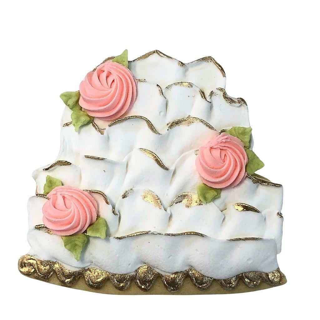 Traditional wedding cake cookie with pink icing roses.