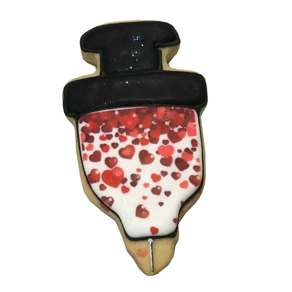 Syringe-shaped cookie decorated with red hearts and black icing