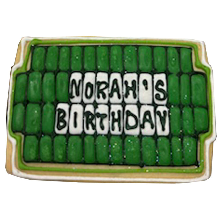 Wheel of Fortune birthday cookie with green and white icing.