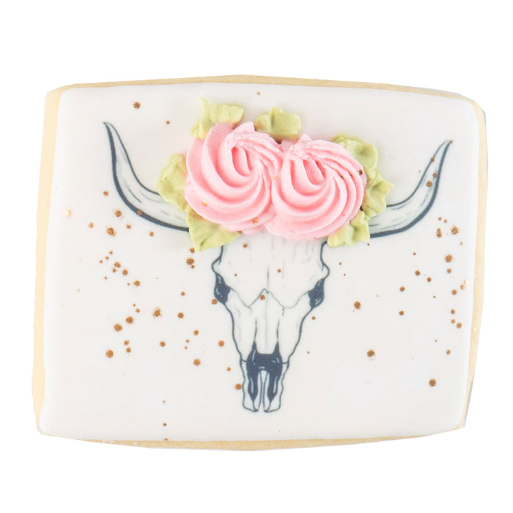 Barnyard Bites cookie with a floral cow skull design