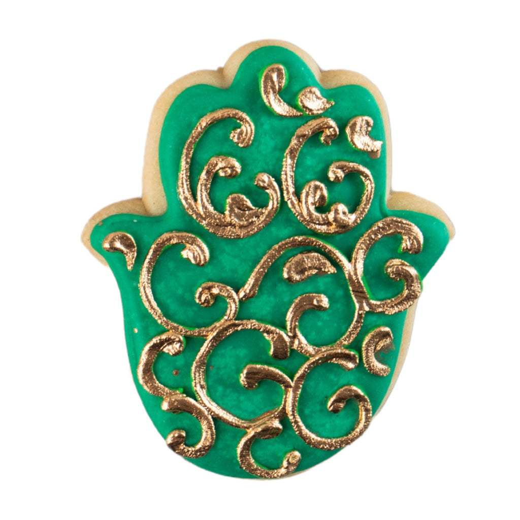 Hamsa-shaped Ramadan butter cookie with green and gold icing.