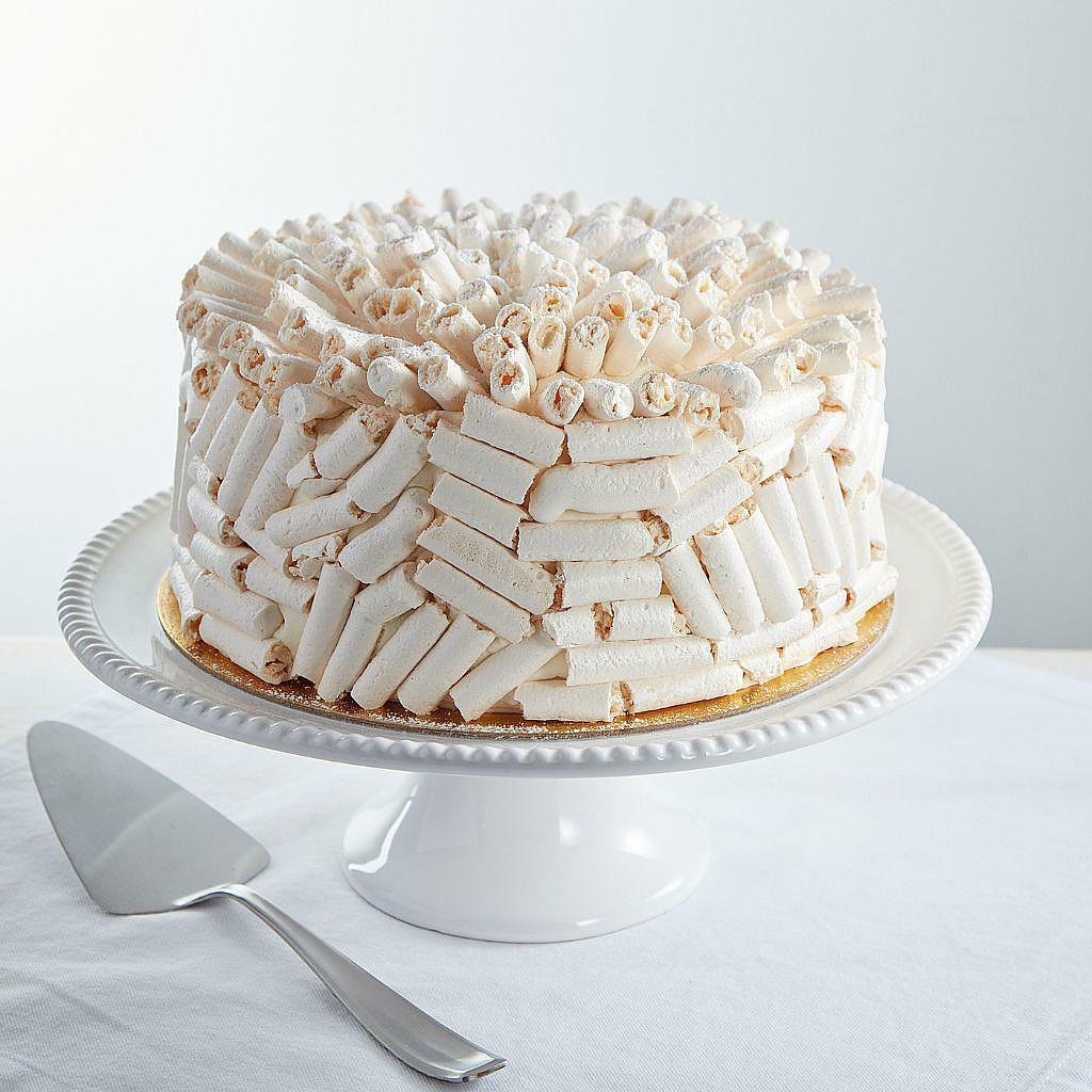9-inch white chocolate Concorde cake covered in meringue sticks