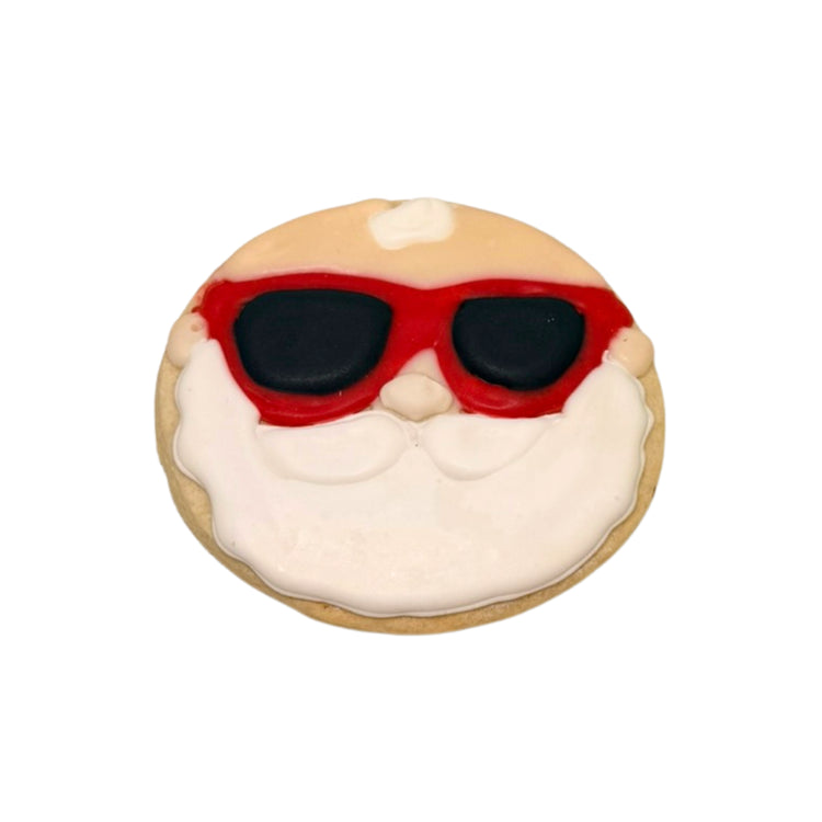 Christmas in July cookie shaped like Santa wearing sunglasses.