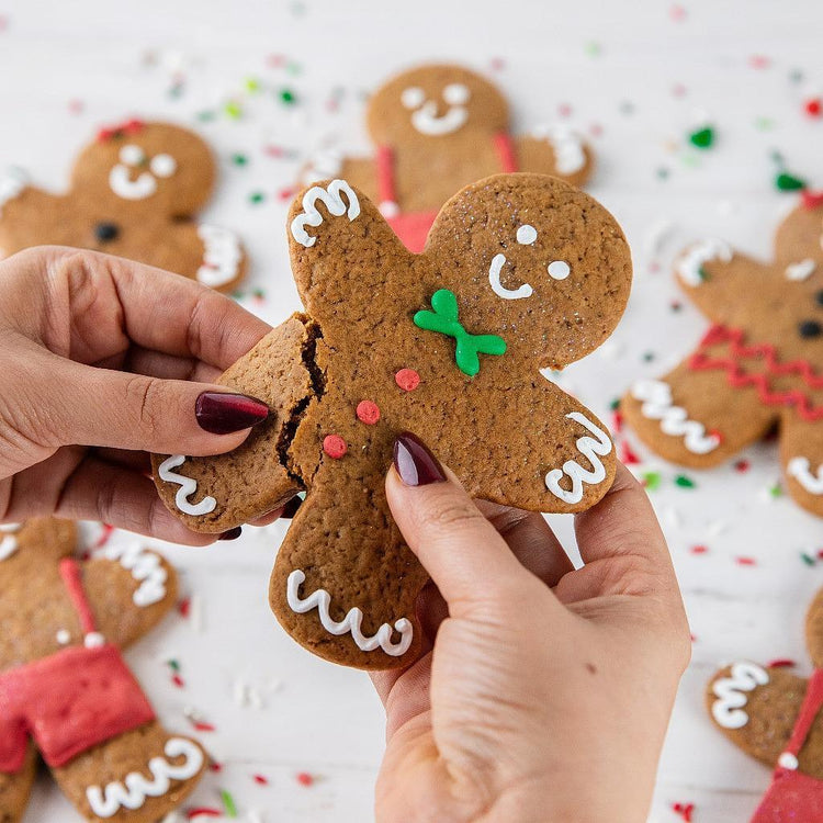 Christmas GingerPeople being broken in half by hands